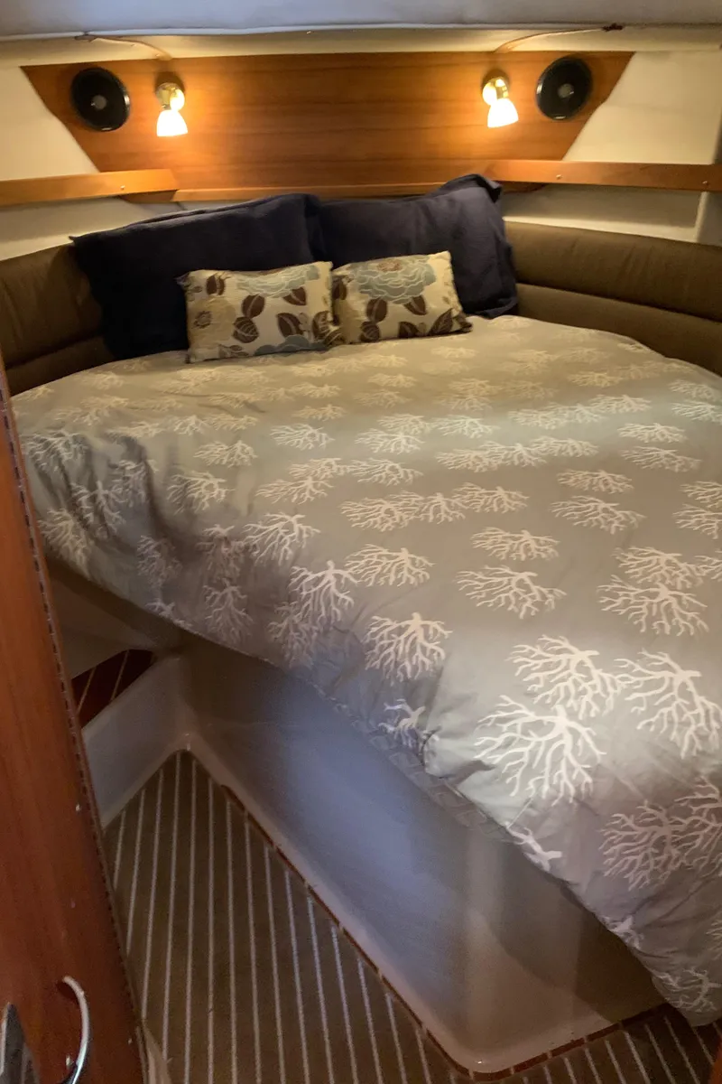 Slide: The Image of 2014 Ranger Tugs Trawler cozy bedroom with nautical-themed bedding. - 24