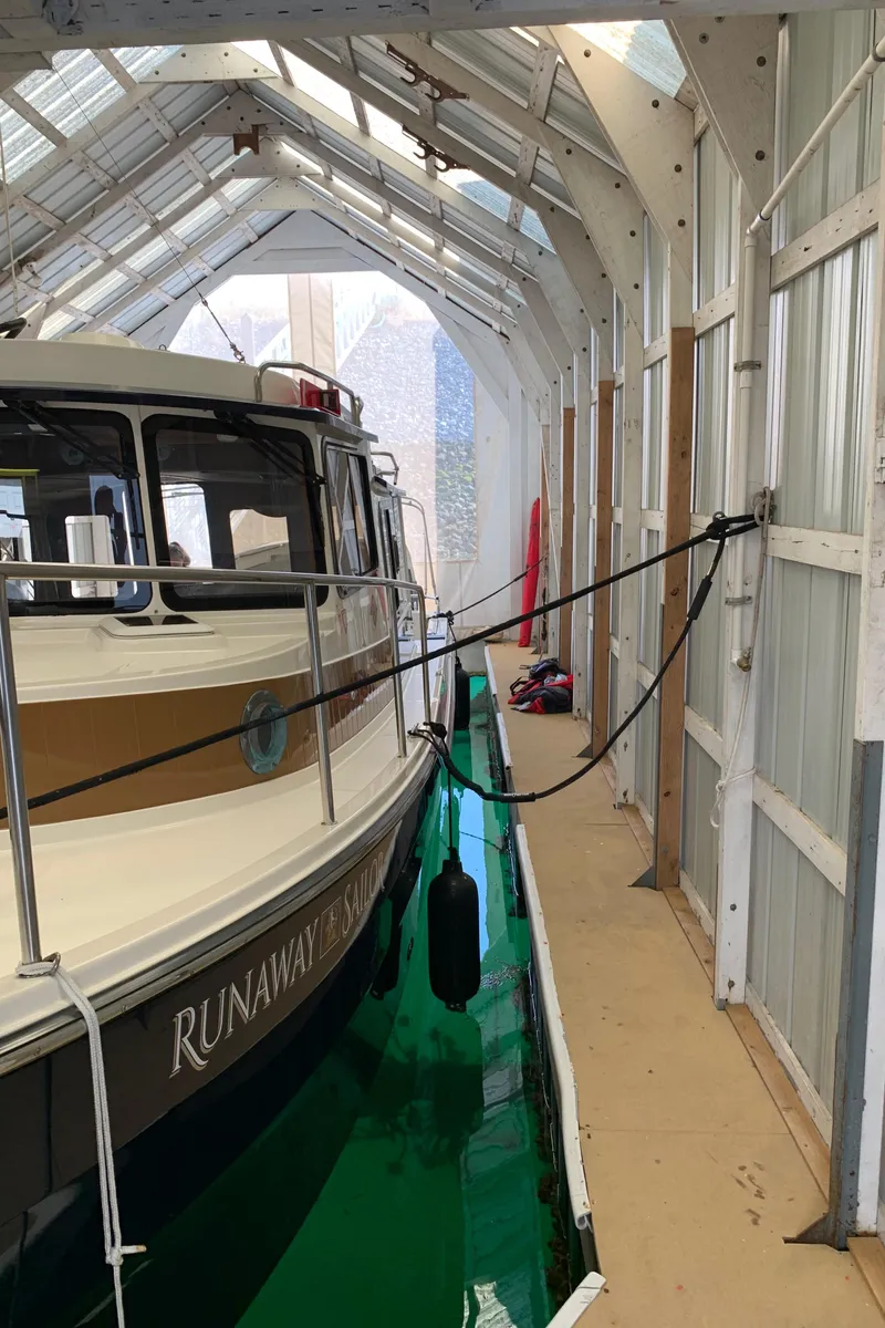 Slide: The Image of 2014 Ranger Tugs Trawler docked in a covered boathouse. - 3