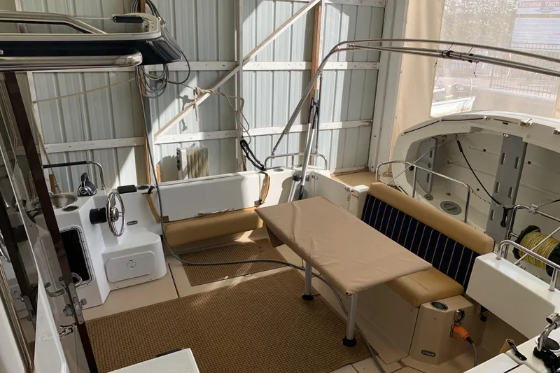 Slide: The Image of 2014 Ranger Tugs Trawler interior with seating and table in a covered dock. - 5