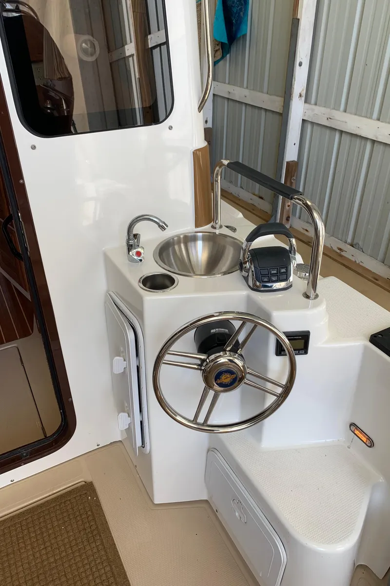 Slide: The Image of 2014 Ranger Tugs Trawler helm station with sink and controls. - 15