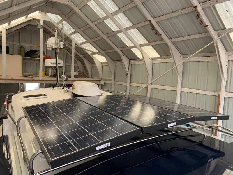 Slide: The Image of 2014 Ranger Tugs Trawler with solar panels in a covered dock. - 2