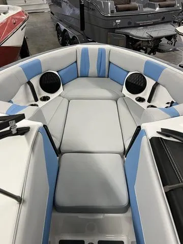 Slide: The Image of 2024 Malibu 22 LSV boat interior with blue and gray seating. - 6
