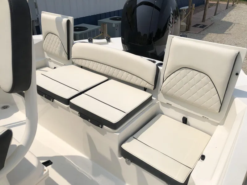 Slide: The Image of 2024 Stingray 216 CC boat with white cushioned seating and black accents. - 11