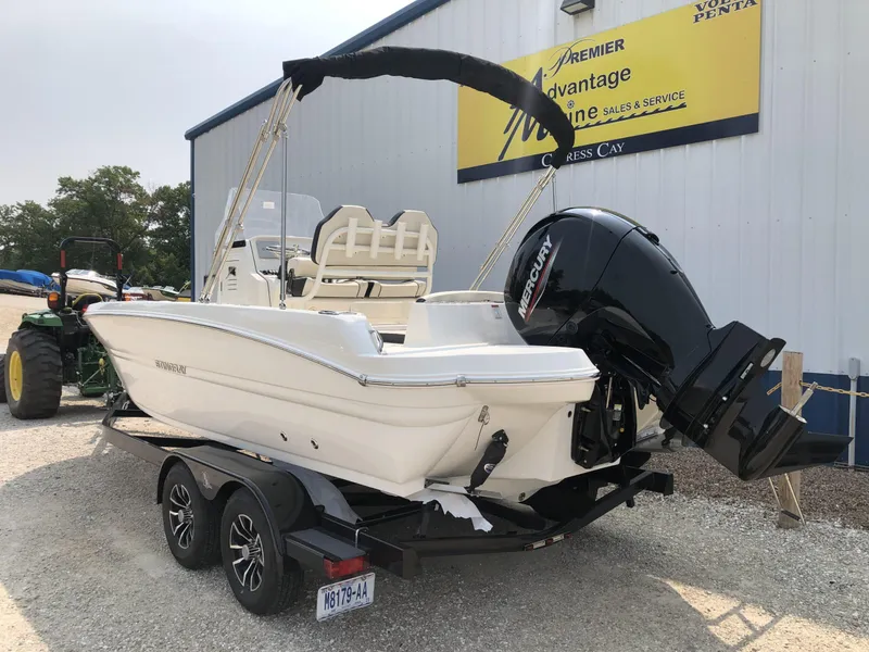 Slide: The Image of 2024 Stingray 216 CC boat on trailer with Mercury outboard motor. - 4