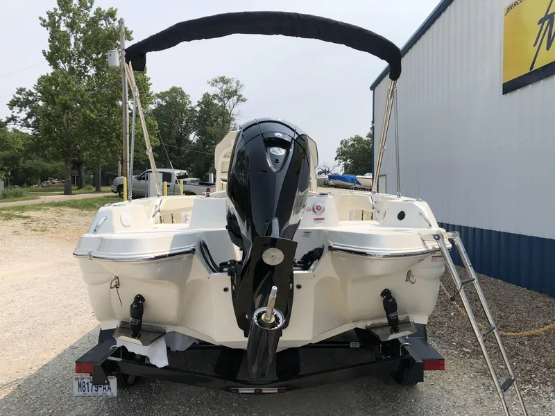Slide: The Image of 2024 Stingray 216 CC boat with outboard motor, rear view, parked on trailer. - 5