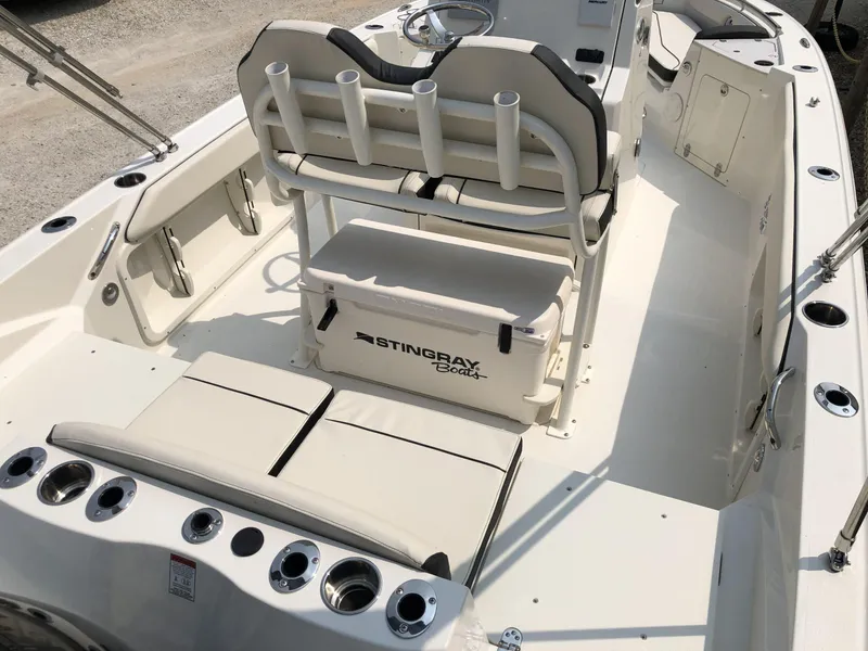 Slide: The Image of 2024 Stingray 216 CC boat interior with seating and rod holders. - 7