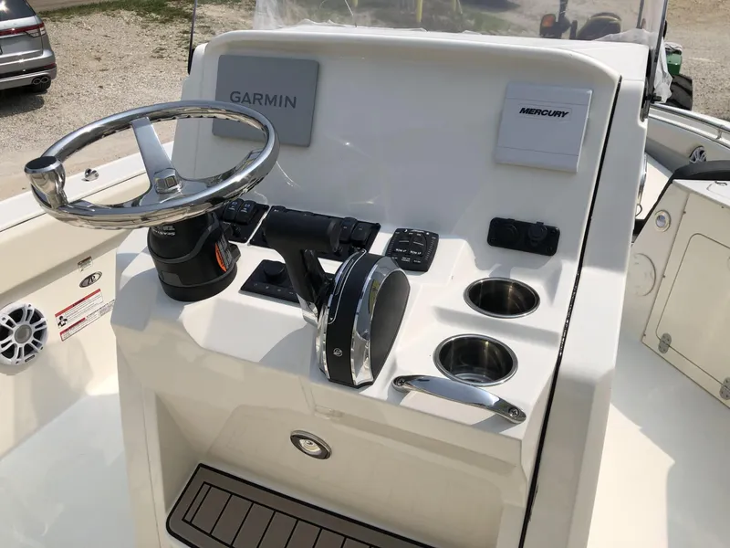 Slide: The Image of 2024 Stingray 216 CC boat console with Garmin and Mercury controls. - 9