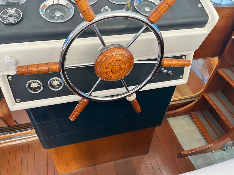Slide: The Image of 1962 Chris-Craft Constellation helm with wooden steering wheel and classic gauges. - 1