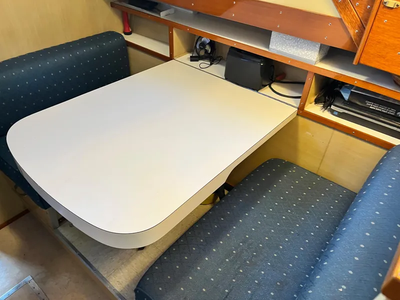 Slide: The Image of 1962 Chris-Craft Constellation interior with dining area and blue upholstered seating. - 10