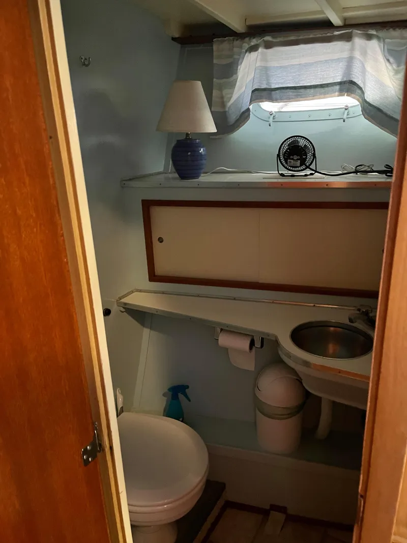 Slide: The Image of 1962 Chris-Craft Constellation bathroom with sink, toilet, and window. - 14