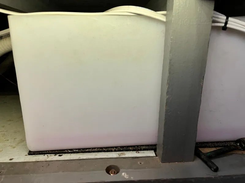 Slide: The Image of 1962 Chris-Craft Constellation interior detail showing a storage compartment with white container. - 19