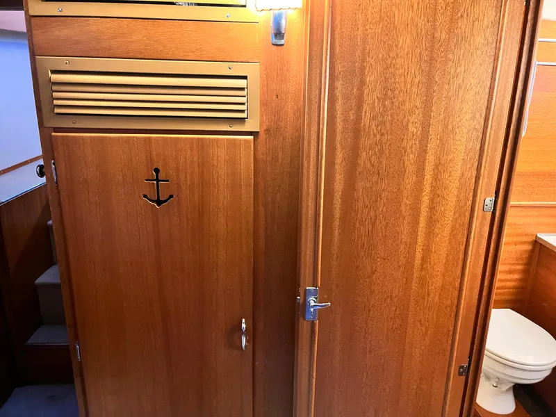 Slide: The Image of 1962 Chris-Craft Constellation interior with wooden cabinetry and nautical-themed decor. - 27