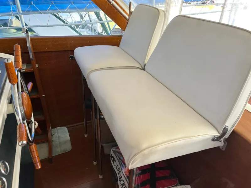 Slide: The Image of 1962 Chris-Craft Constellation interior with white cushioned seating and wooden accents. - 3