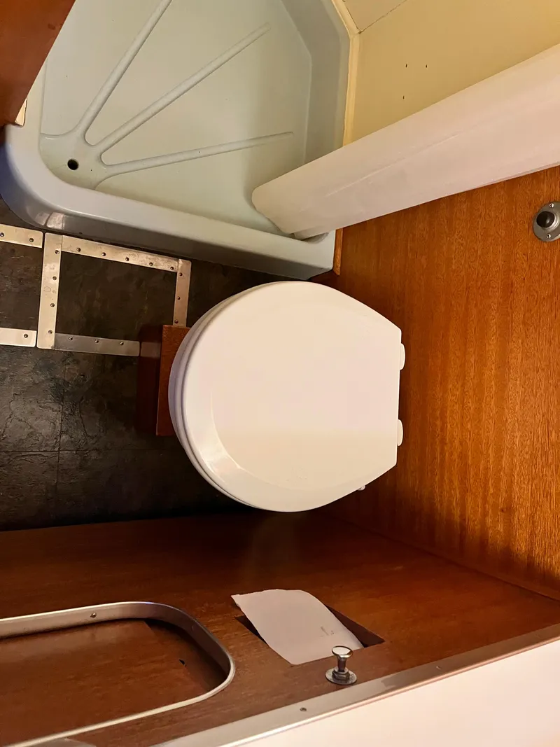 Slide: The Image of 1962 Chris-Craft Constellation bathroom with wooden interior and compact toilet design. - 31