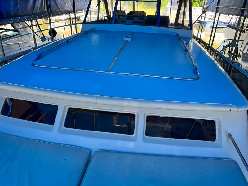 Slide: The Image of 1962 Chris-Craft Constellation boat with blue deck, docked under a canopy. - 33
