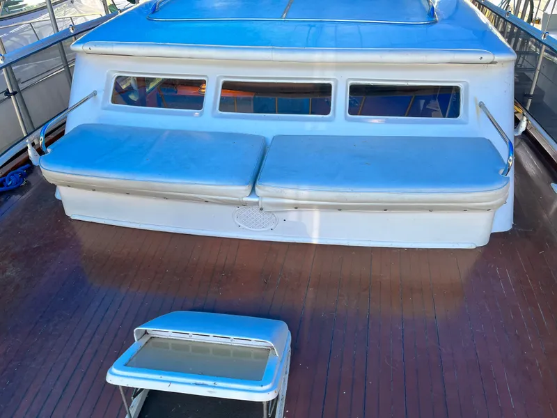 Slide: The Image of 1962 Chris-Craft Constellation boat deck with blue cushions and wooden flooring. - 34