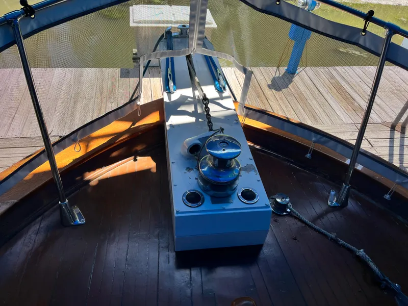 Slide: The Image of 1962 Chris-Craft Constellation boat deck with winch and wooden flooring. - 35