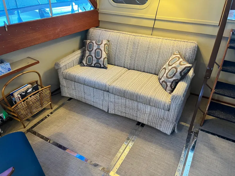 Slide: The Image of Vintage 1962 Chris-Craft Constellation interior with a cozy sofa and decorative pillows. - 46