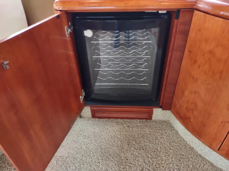 Slide: The Image of Built-in wine cooler in 1997 Fairline 66 yacht with wooden cabinetry. - 12