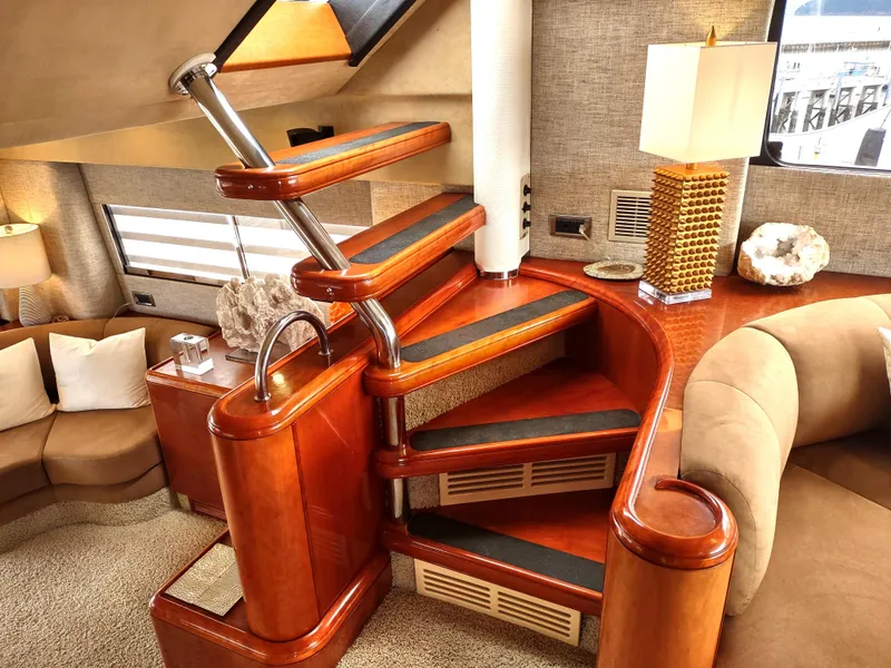 Slide: The Image of Luxurious interior of a 1997 Fairline 66 yacht with wooden staircase and modern decor. - 15