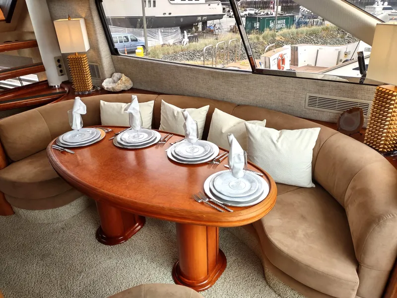 Slide: The Image of Luxurious dining area on a 1997 Fairline 66 yacht with elegant table setting. - 17