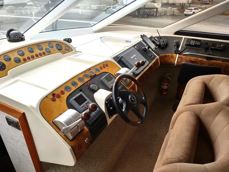 Slide: The Image of Cockpit of a 1997 Fairline 66 yacht with steering wheel and control panels. - 18