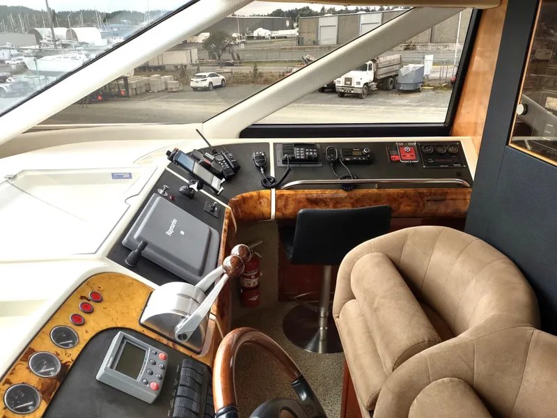 Slide: The Image of Interior helm of a 1997 Fairline 66 yacht with navigation equipment and plush seating. - 19