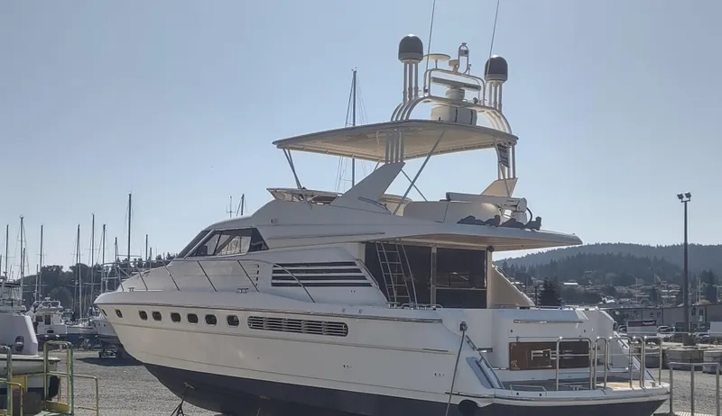 Slide: The Image of 1997 Fairline 66 yacht docked in a marina under clear skies. - 2
