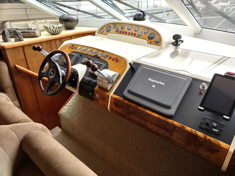 Slide: The Image of 1997 Fairline 66 yacht helm station with steering wheel and navigation equipment. - 20