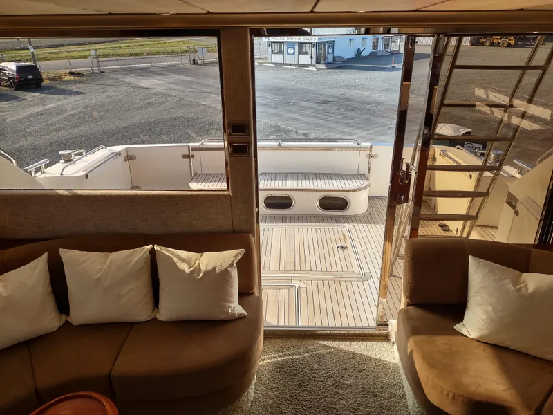 Slide: The Image of Interior view of 1997 Fairline 66 yacht, showing seating area and deck access. - 24