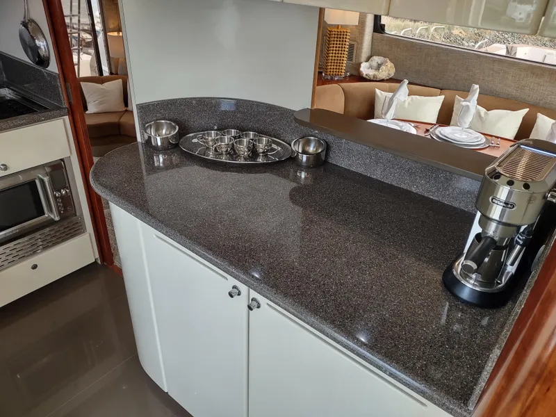 Slide: The Image of 1997 Fairline 66 yacht kitchen with granite countertops and modern appliances. - 25