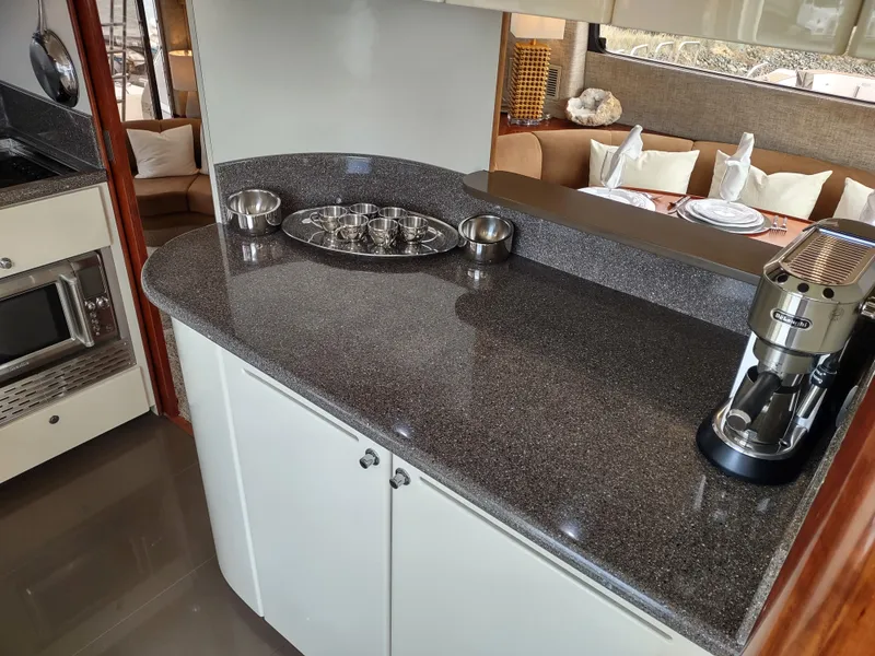Slide: The Image of Fairline 66 1997 yacht kitchen with granite countertops and modern appliances. - 26