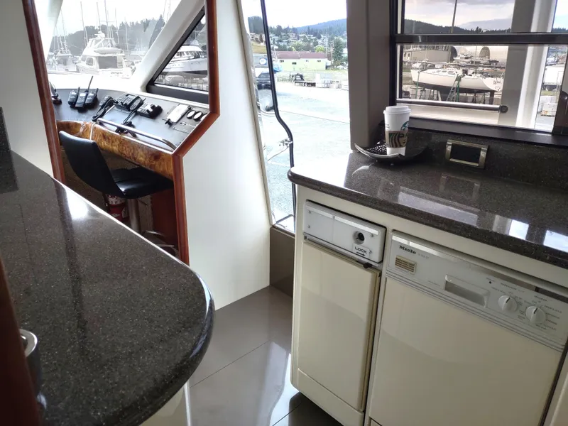 Slide: The Image of Interior of 1997 Fairline 66 yacht with helm station and galley area. - 29