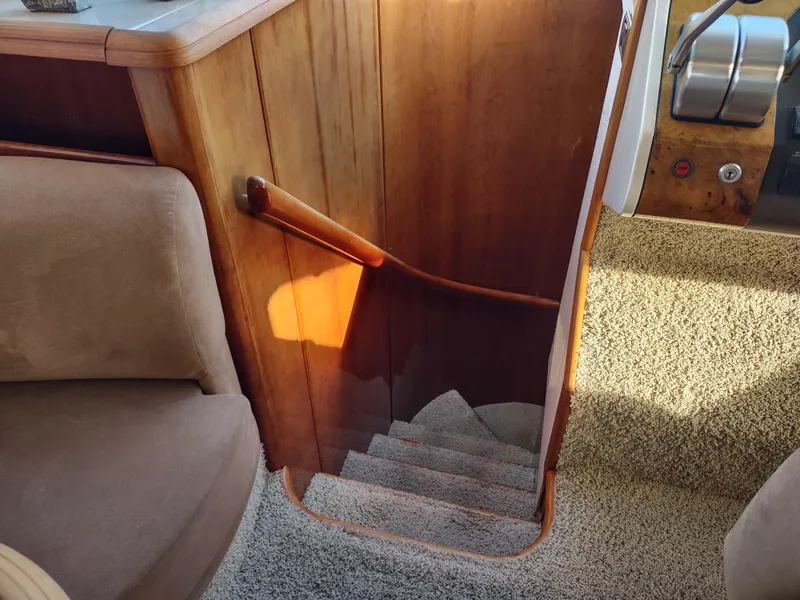 Slide: The Image of Staircase inside a 1997 Fairline 66 yacht with wooden handrail and carpeted steps. - 32