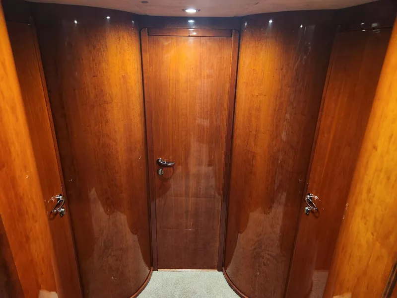 Slide: The Image of Interior hallway of 1997 Fairline 66 yacht with polished wooden doors. - 34