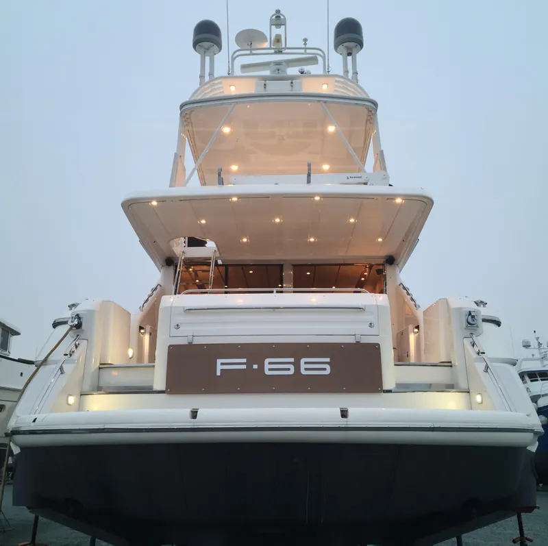 Slide: The Image of 1997 Fairline 66 yacht, rear view with illuminated deck and F-66 signage. - 4
