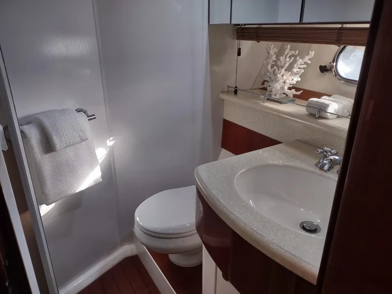 Slide: The Image of Luxurious bathroom on a 1997 Fairline 66 yacht with modern fixtures and elegant decor. - 42