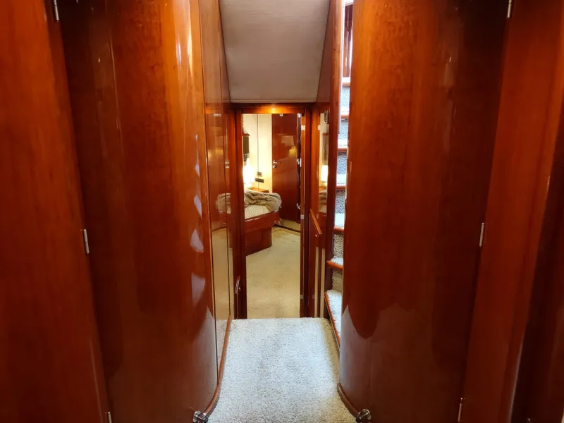 Slide: The Image of Hallway inside a 1997 Fairline 66 yacht with polished wood paneling. - 45