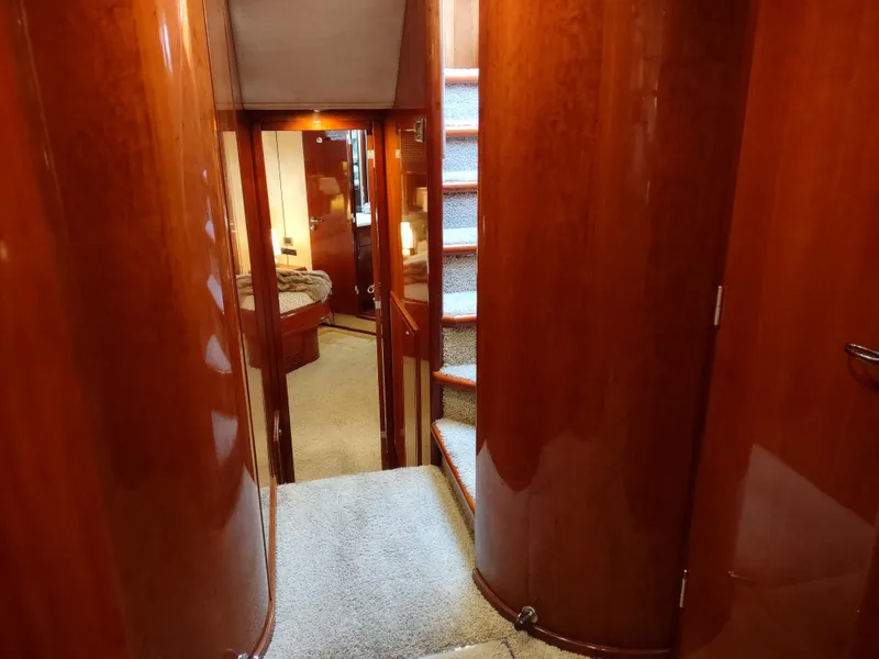 Slide: The Image of Interior hallway of 1997 Fairline 66 yacht with wooden paneling and carpeted stairs. - 46