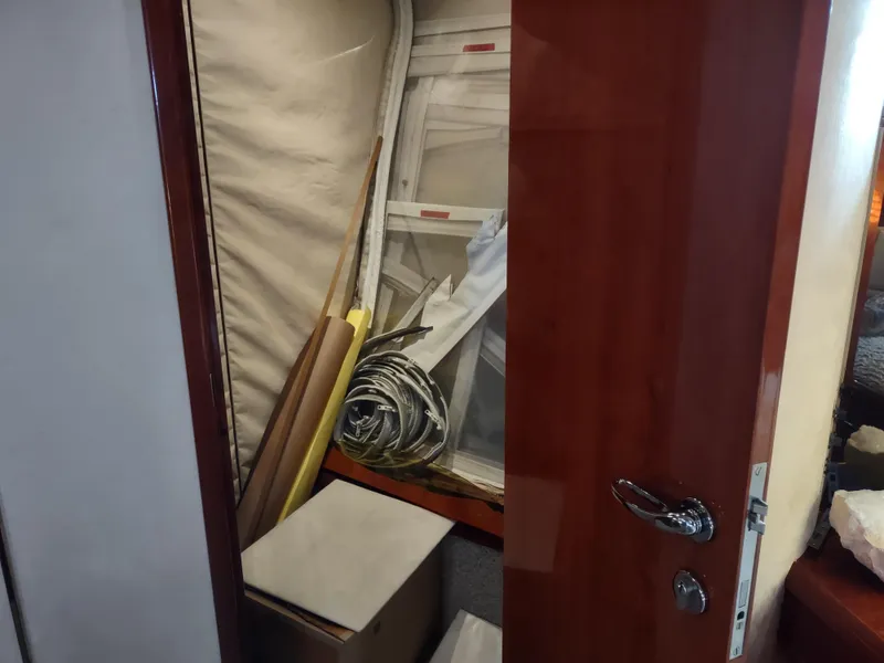 Slide: The Image of Storage area inside a 1997 Fairline 66 yacht, containing various materials and equipment. - 49