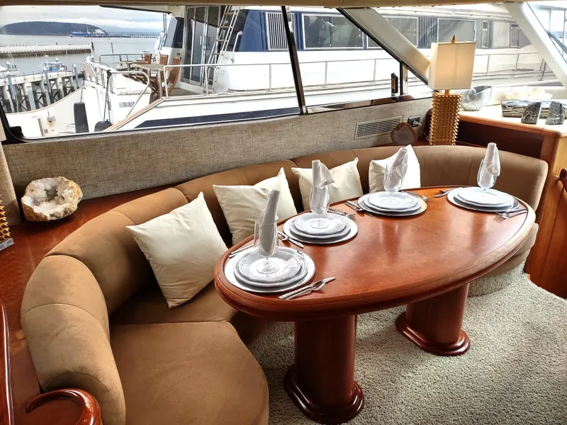 Slide: The Image of Luxurious dining area inside a 1997 Fairline 66 yacht, set with elegant tableware. - 9