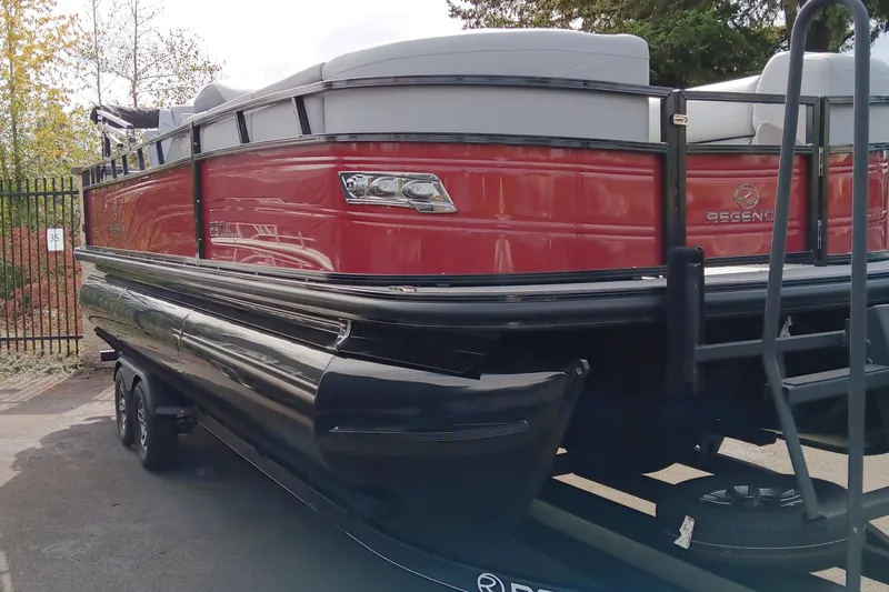 Slide: The Image of 2024 Regency 250 DL3 pontoon boat with red and black exterior. - 2