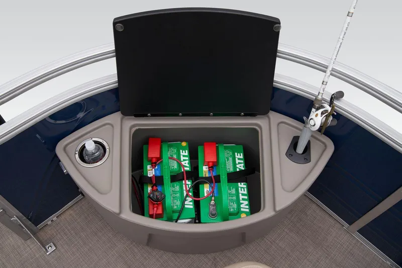 Slide: The Image of 2024 Sun Tracker Fishin' Barge 22 XP3 battery compartment and fishing rod holder. - 29
