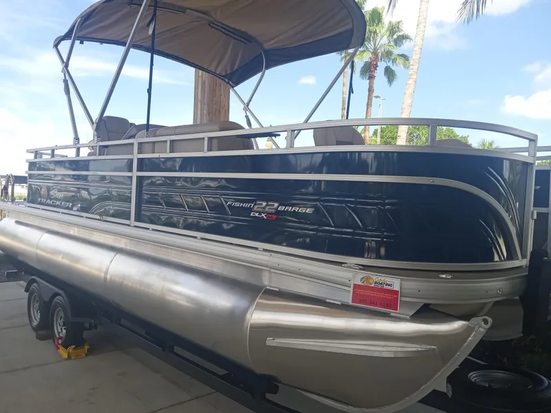 Slide: The Image of 2024 Sun Tracker Fishin' Barge 22 XP3 pontoon boat with canopy on trailer. - 5