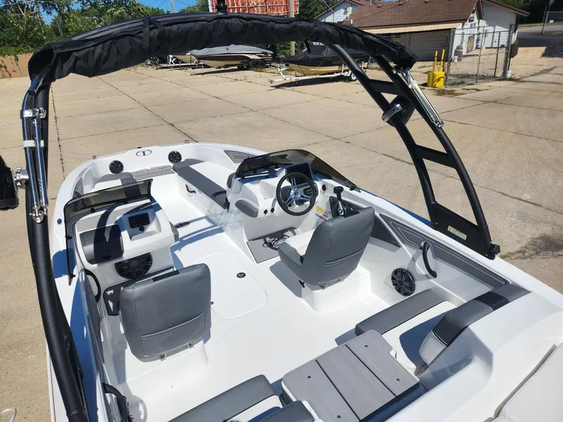 Slide: The Image of 2024 Tahoe T21 boat interior with seating and steering wheel. - 20