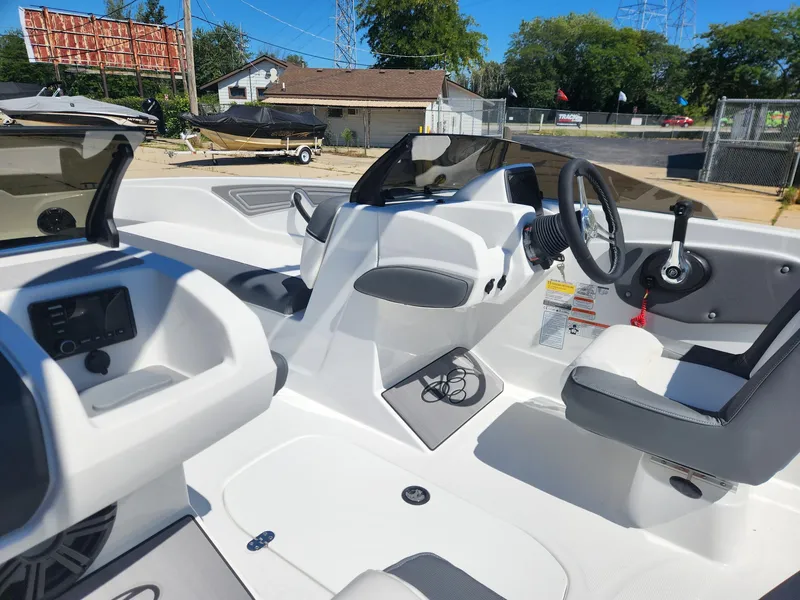 Slide: The Image of 2024 Tahoe T21 boat interior with steering wheel, seats, and control panel. - 22