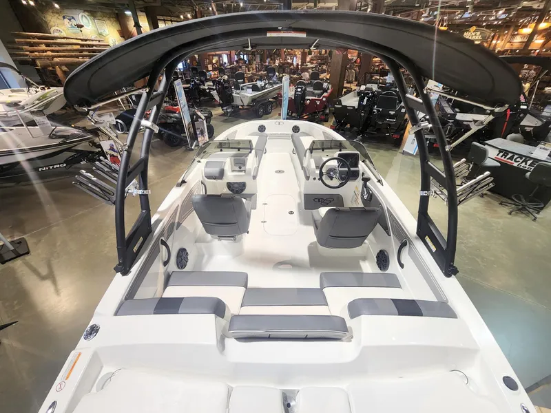 Slide: The Image of 2024 Tahoe T21 boat interior with seating and control console in showroom. - 3