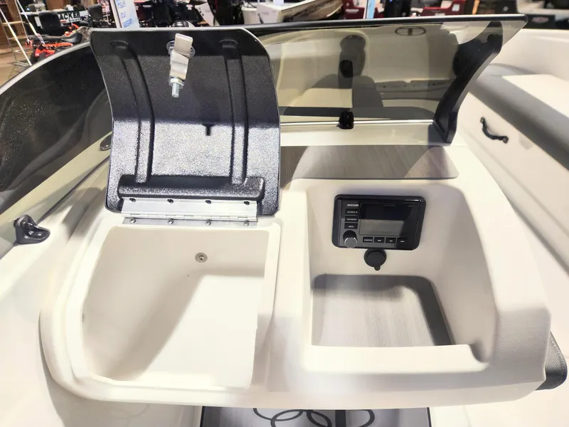 Slide: The Image of 2024 Tahoe T21 boat dashboard with storage compartment and control panel. - 4