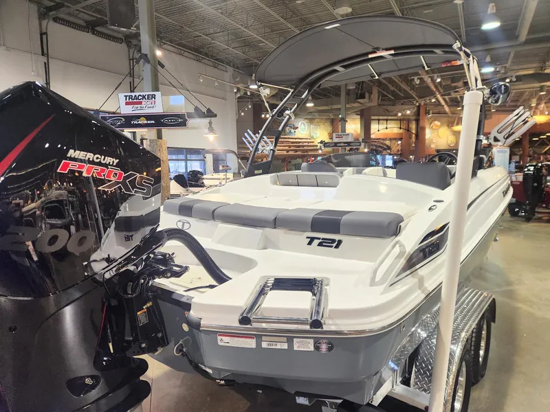 Slide: The Image of 2024 Tahoe T21 boat with Mercury Pro XS engine displayed indoors. - 5