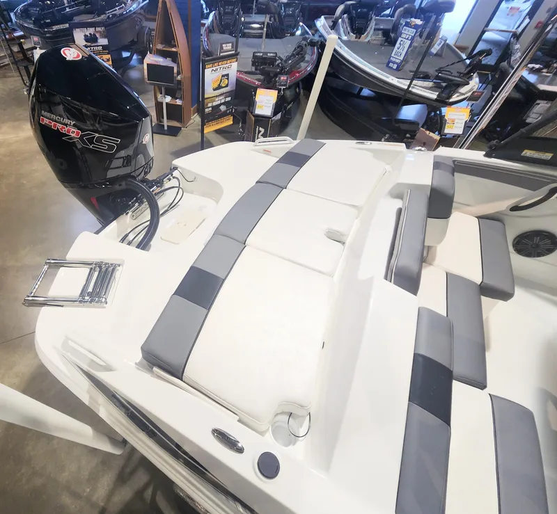 Slide: The Image of 2024 Tahoe T21 boat interior with seating and outboard motor in showroom. - 7